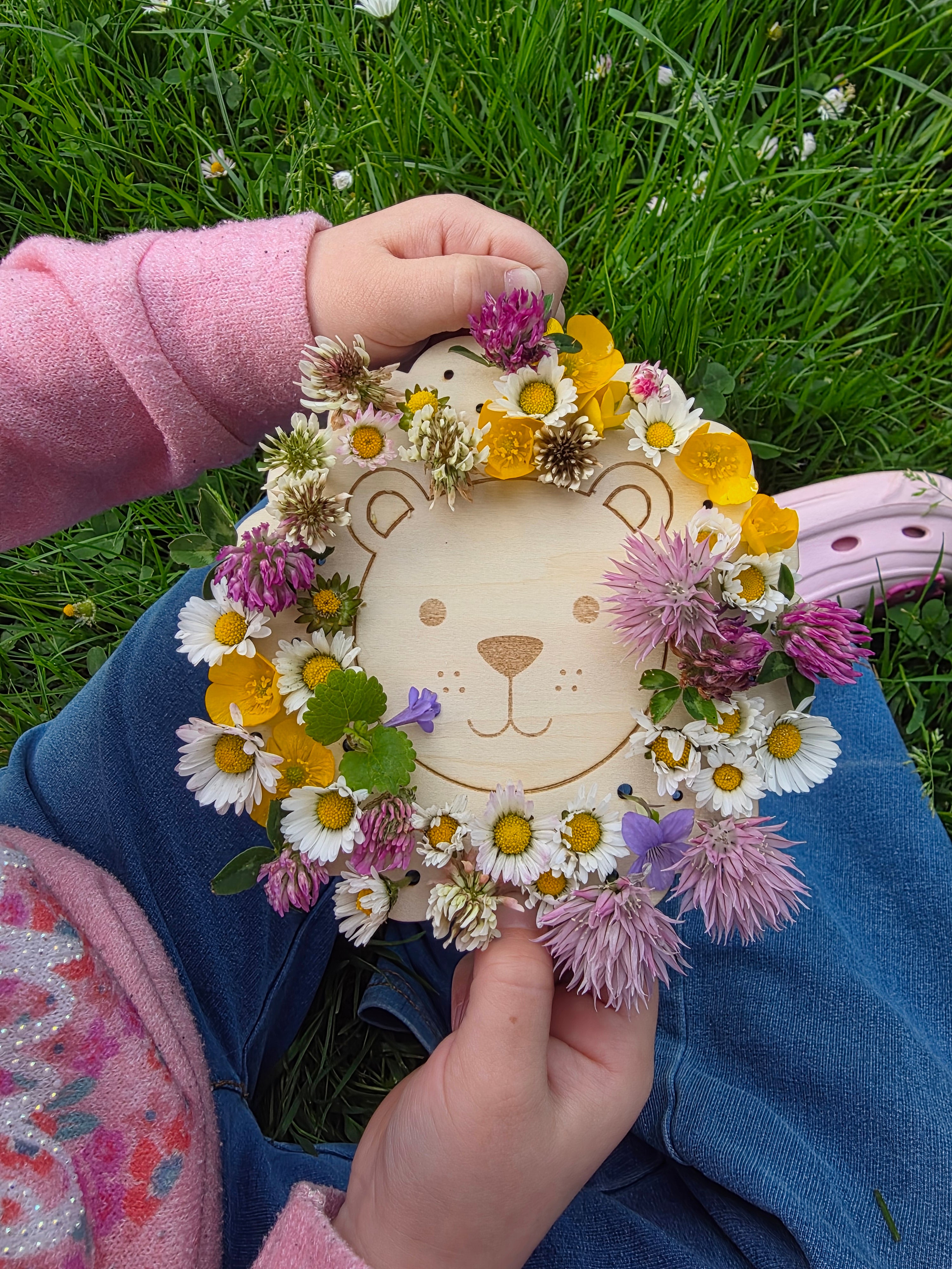 Enfant composant son tableau lion avec des fleurs